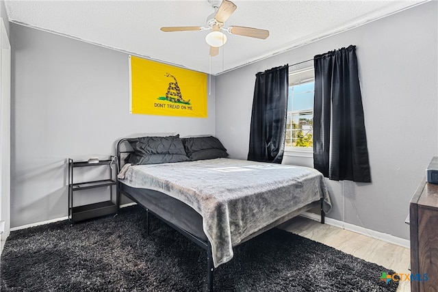 bedroom with a textured ceiling and ceiling fan