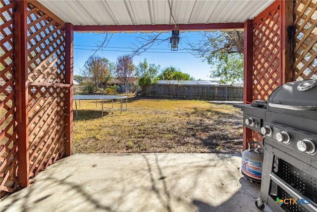 view of yard featuring a patio area and a trampoline