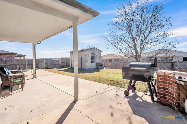 view of patio with a grill and a storage shed