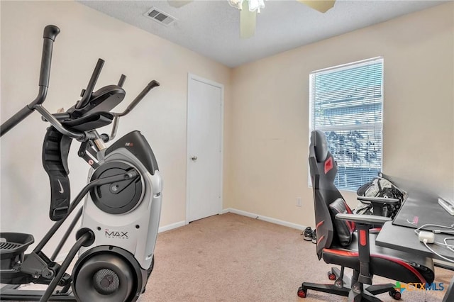 workout room featuring ceiling fan and light carpet