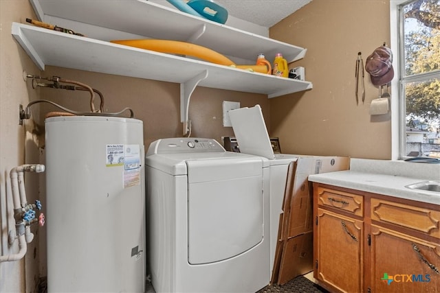 laundry area featuring a sink, cabinet space, washing machine and dryer, and gas water heater