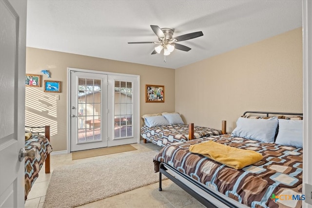 bedroom with access to exterior, french doors, and a ceiling fan