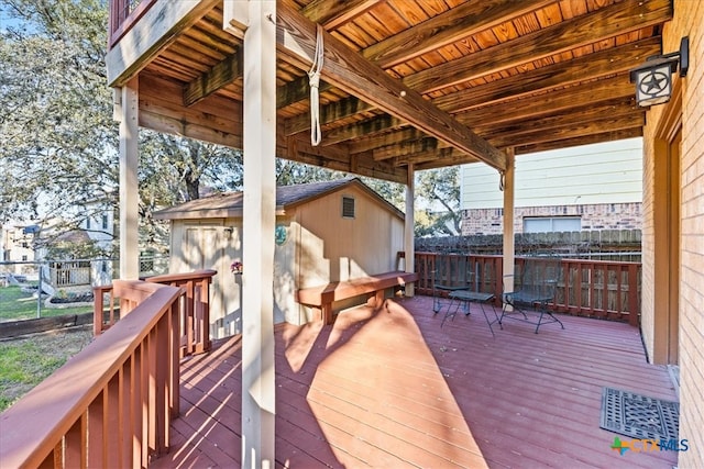 wooden terrace with an outbuilding and fence