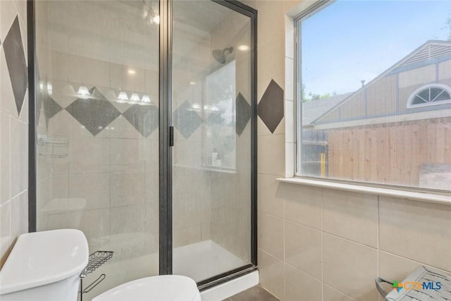 606 Brazos Dr, Temple, TX 76504 - full bathroom featuring a stall shower, healthy amount of natural light, and tile walls