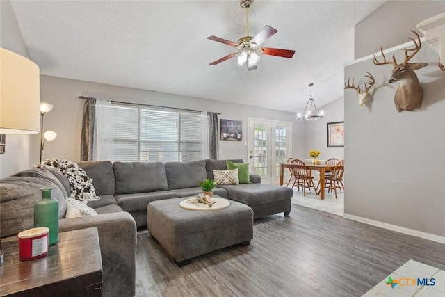 606 Brazos Dr, Temple, TX 76504 - living room featuring lofted ceiling, ceiling fan, a textured ceiling, wood finished floors, and a chandelier
