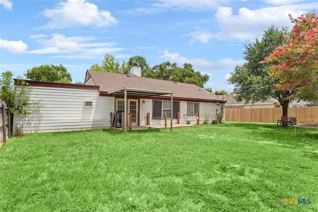 606 Brazos Dr, Temple, TX 76504 - back of property with a fenced backyard, french doors, a shingled roof, a patio, and a chimney