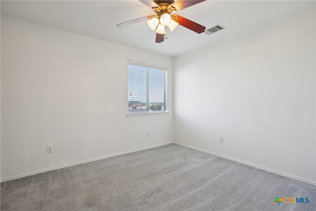 empty room featuring light carpet and ceiling fan