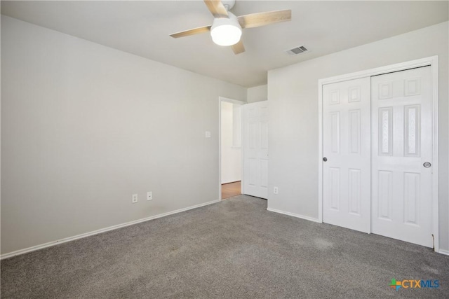 unfurnished bedroom featuring a closet, ceiling fan, and dark colored carpet