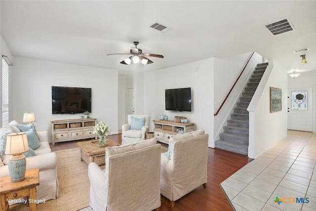 living room featuring a wealth of natural light, wood-type flooring, and ceiling fan