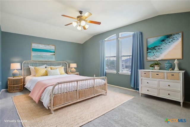 bedroom with vaulted ceiling, light colored carpet, and ceiling fan