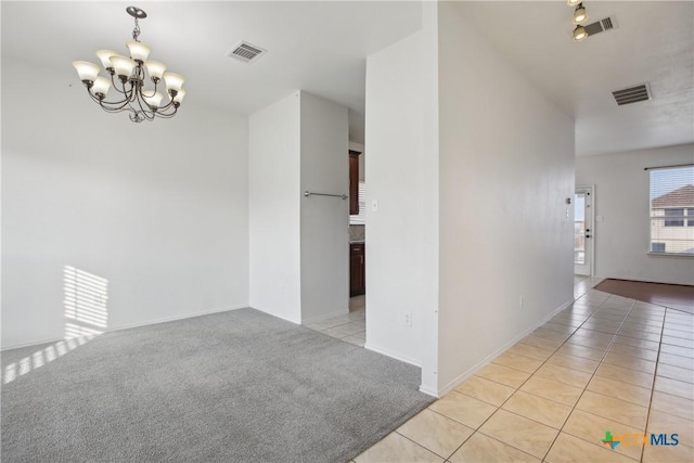 interior space with light tile patterned flooring and a notable chandelier