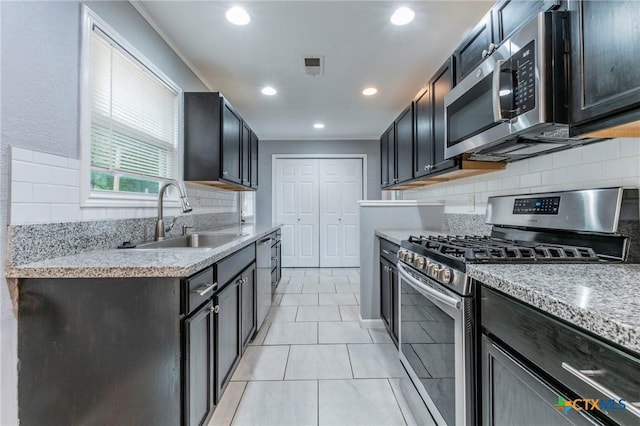 1109 Meadow Dr, Killeen, TX 76549 - kitchen featuring appliances with stainless steel finishes, a sink, backsplash, recessed lighting, and light tile patterned floors