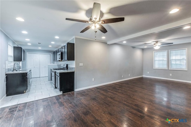 1109 Meadow Dr, Killeen, TX 76549 - kitchen featuring stainless steel appliances, a ceiling fan, wood finished floors, a sink, and recessed lighting