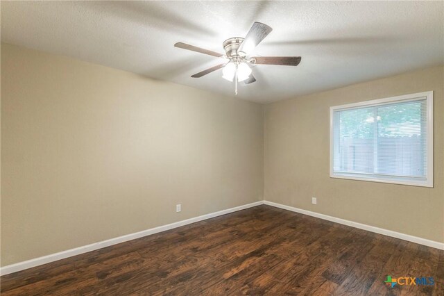 1109 Meadow Dr, Killeen, TX 76549 - empty room featuring dark wood-type flooring, baseboards, ceiling fan, and a textured ceiling