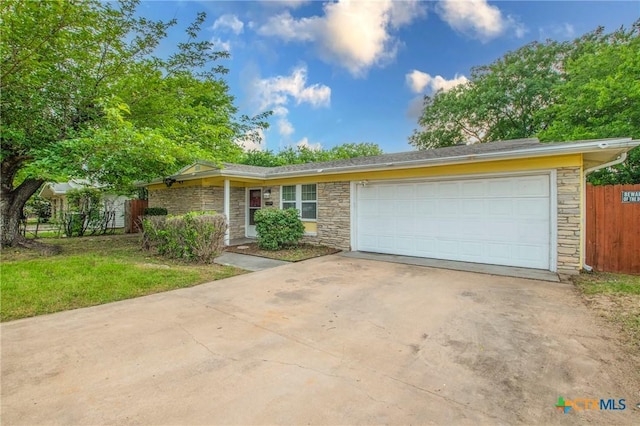 1109 Meadow Dr, Killeen, TX 76549 - view of front of property with stone siding, concrete driveway, a garage, and fence