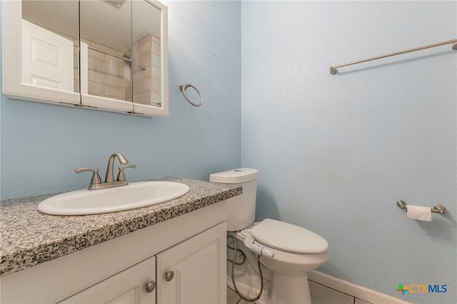 1109 Meadow Dr, Killeen, TX 76549 - bathroom featuring toilet, vanity, and tile patterned flooring