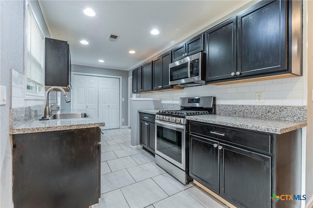 1109 Meadow Dr, Killeen, TX 76549 - kitchen with stainless steel appliances, a sink, tasteful backsplash, light tile patterned floors, and recessed lighting