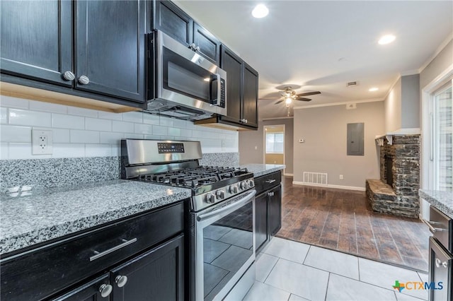 1109 Meadow Dr, Killeen, TX 76549 - kitchen with appliances with stainless steel finishes, ornamental molding, a ceiling fan, electric panel, and light stone counters