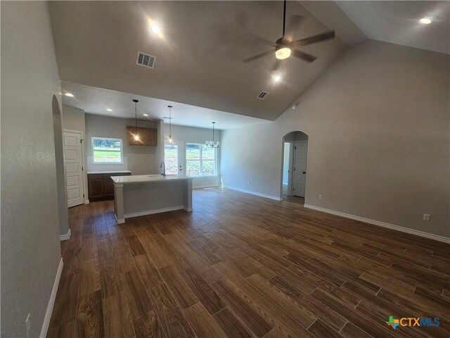 unfurnished room featuring ceiling fan, dark wood-type flooring, visible vents, and baseboards