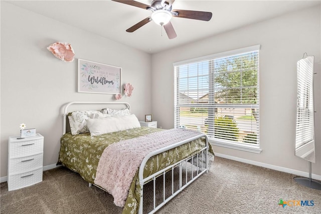 bedroom with multiple windows, baseboards, and carpet