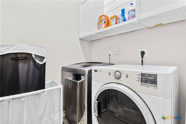 washroom with cabinet space and independent washer and dryer