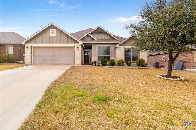 view of front of house with a front lawn, a garage, board and batten siding, and driveway