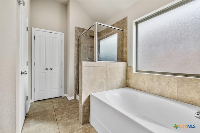 full bathroom with a shower stall, plenty of natural light, and a bath