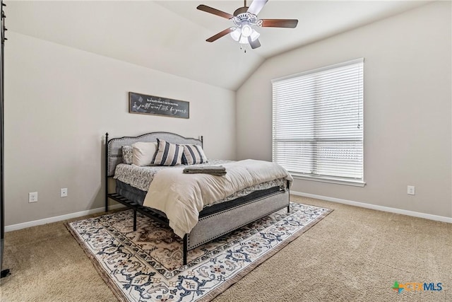 carpeted bedroom with baseboards, lofted ceiling, and a ceiling fan