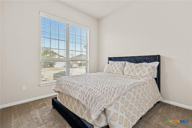 bedroom with baseboards and carpet