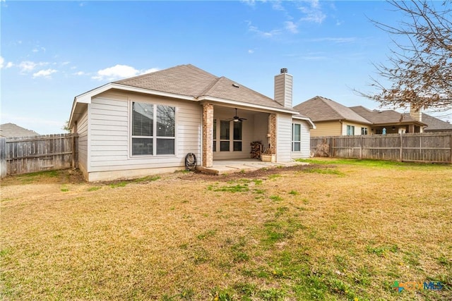 back of house featuring a fenced backyard, a patio area, a lawn, and ceiling fan