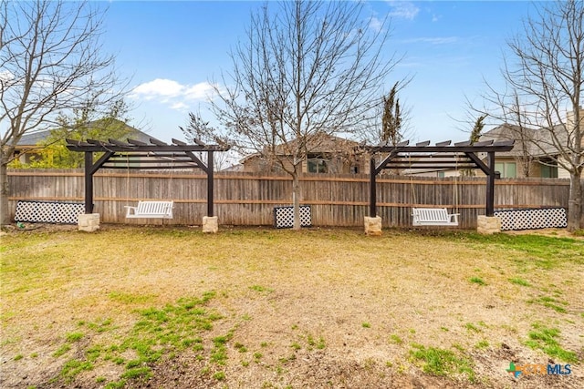 view of yard with a pergola and fence