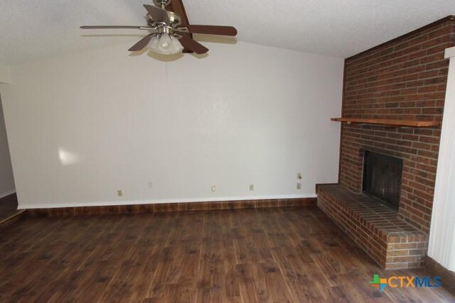 unfurnished living room with ceiling fan, a fireplace, baseboards, wood-type flooring, and lofted ceiling