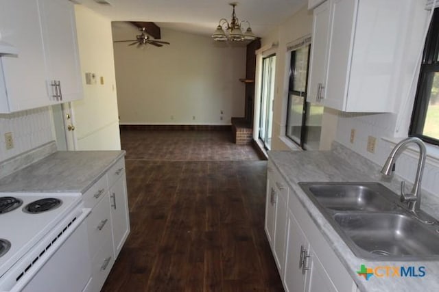 kitchen featuring white cabinets, dark wood finished floors, a sink, and light countertops