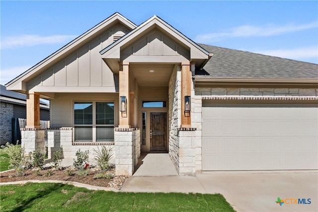 7310 Caladium Dr, Temple, TX 76502 - view of front of home with stone siding, board and batten siding, an attached garage, concrete driveway, and a shingled roof