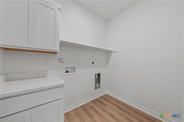 laundry room with cabinets, washer hookup, electric dryer hookup, hookup for a gas dryer, and light hardwood / wood-style floors