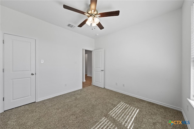 unfurnished bedroom featuring carpet floors and ceiling fan