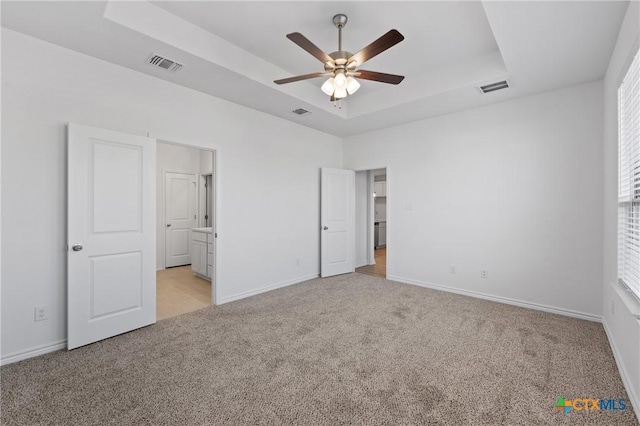 7310 Caladium Dr, Temple, TX 76502 - unfurnished bedroom featuring a raised ceiling, light colored carpet, baseboards, and ceiling fan