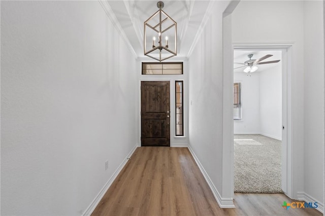 7310 Caladium Dr, Temple, TX 76502 - entrance foyer with light wood-type flooring, ornamental molding, a chandelier, baseboards, and ceiling fan