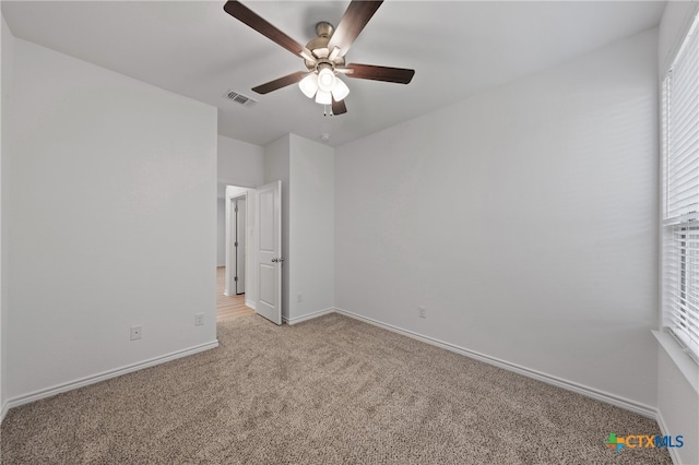 unfurnished bedroom featuring ceiling fan and light carpet