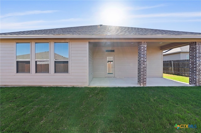 back of house featuring a yard and a patio