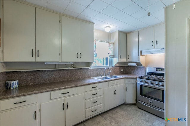 807 E 12th Ave, Belton, TX 76513 - kitchen with stainless steel gas range, under cabinet range hood, and light tile patterned flooring