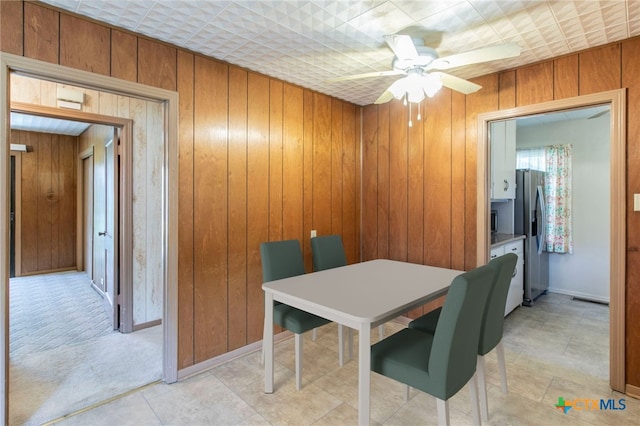 807 E 12th Ave, Belton, TX 76513 - dining space featuring wooden walls and a ceiling fan
