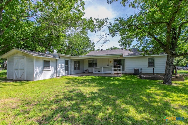 807 E 12th Ave, Belton, TX 76513 - back of house with a patio, a lawn, and a storage unit