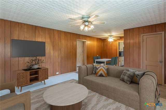807 E 12th Ave, Belton, TX 76513 - living room featuring ceiling fan, carpet floors, and wooden walls