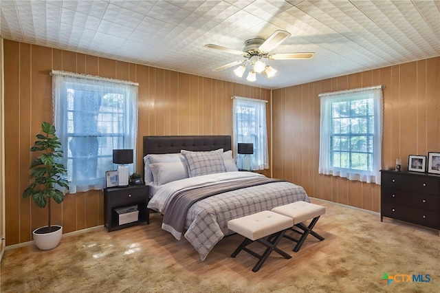 807 E 12th Ave, Belton, TX 76513 - carpeted bedroom featuring wooden walls and a ceiling fan