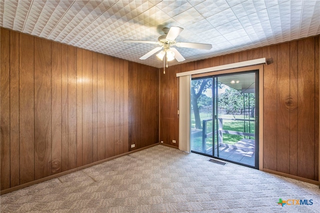 807 E 12th Ave, Belton, TX 76513 - carpeted empty room with wooden walls and a ceiling fan