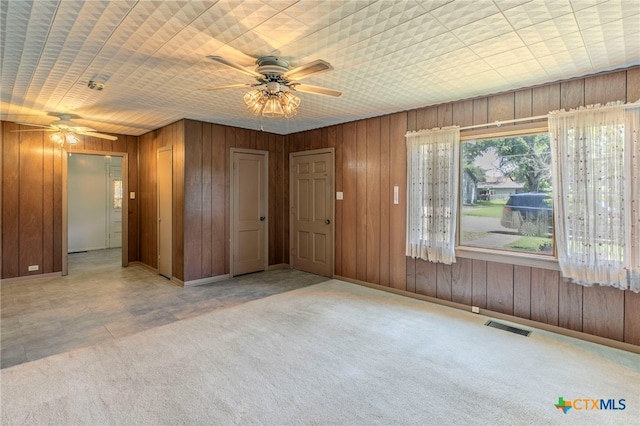 807 E 12th Ave, Belton, TX 76513 - carpeted spare room with ceiling fan and wood walls
