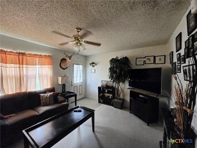 living room with a textured ceiling and a ceiling fan