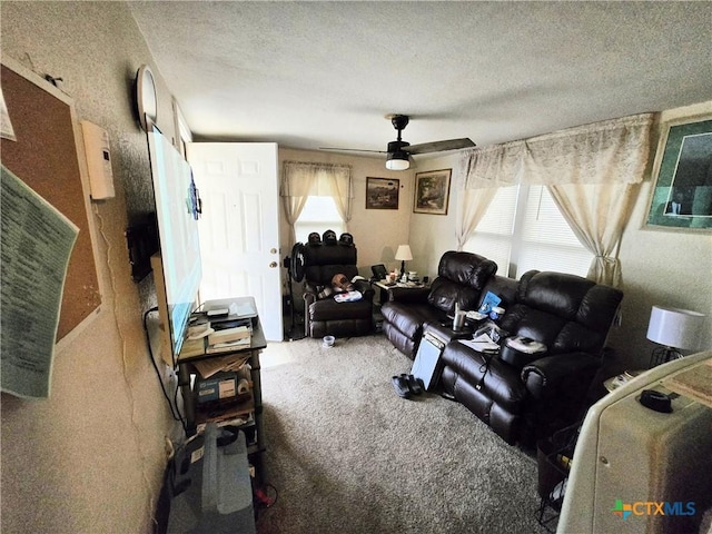 carpeted living room with a ceiling fan and a textured ceiling