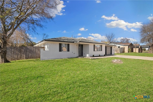 ranch-style home with a front yard and a garage